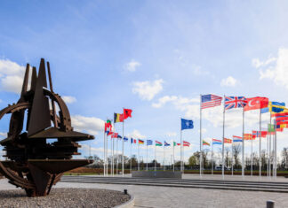 Conroy heads to TĂĽrkiye for NATO summit 32 flags monument